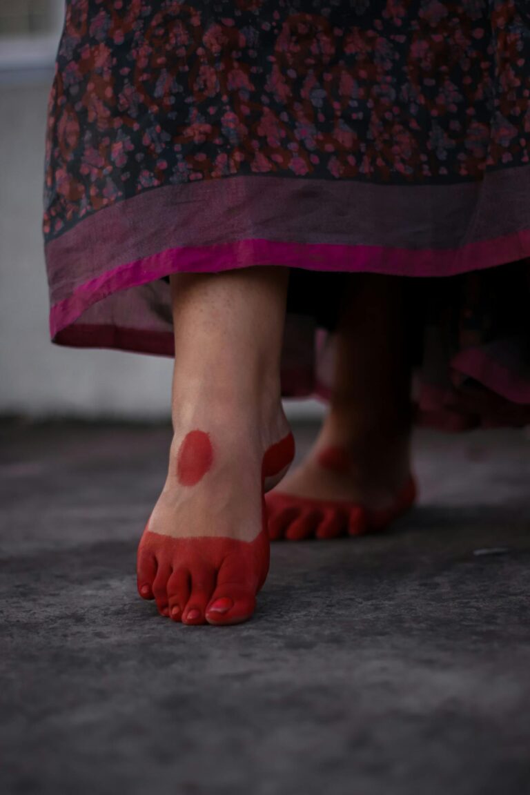 Close-up of red-stained feet with Mahavar in Dhaka, showcasing traditional art.
